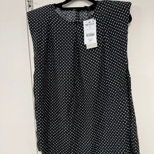 Black and white polka dot blouse