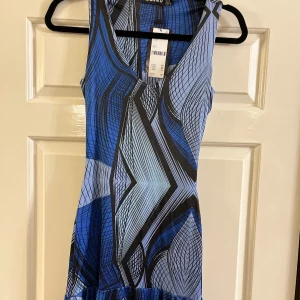 Printed Plunge Neck & Frill Hem Urban Outfitters Micro Mini Dress. Blue, Black